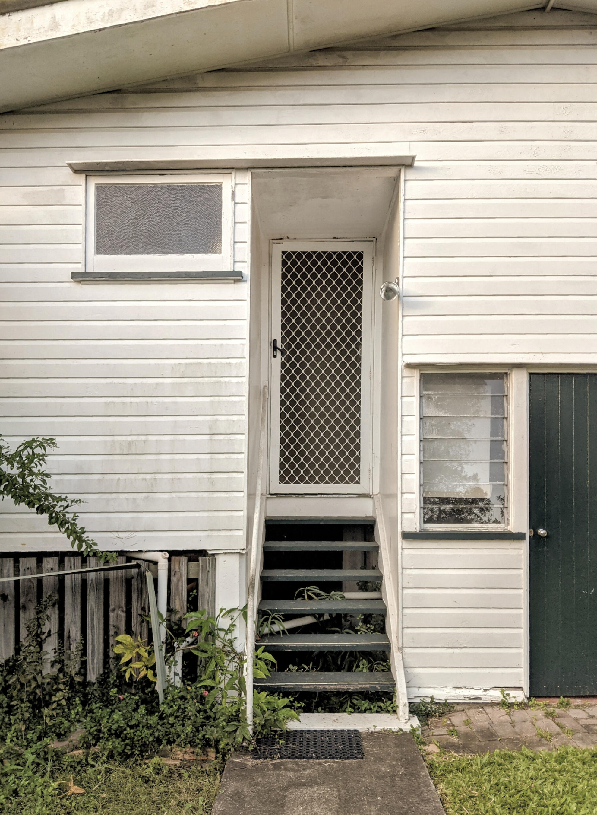 Oxley Farmhouse Existing Rear Facade and Steps Studio Violett Oxley Farmhouse existing rear facade and timber entry stairs showing original weatherboard cladding and datums