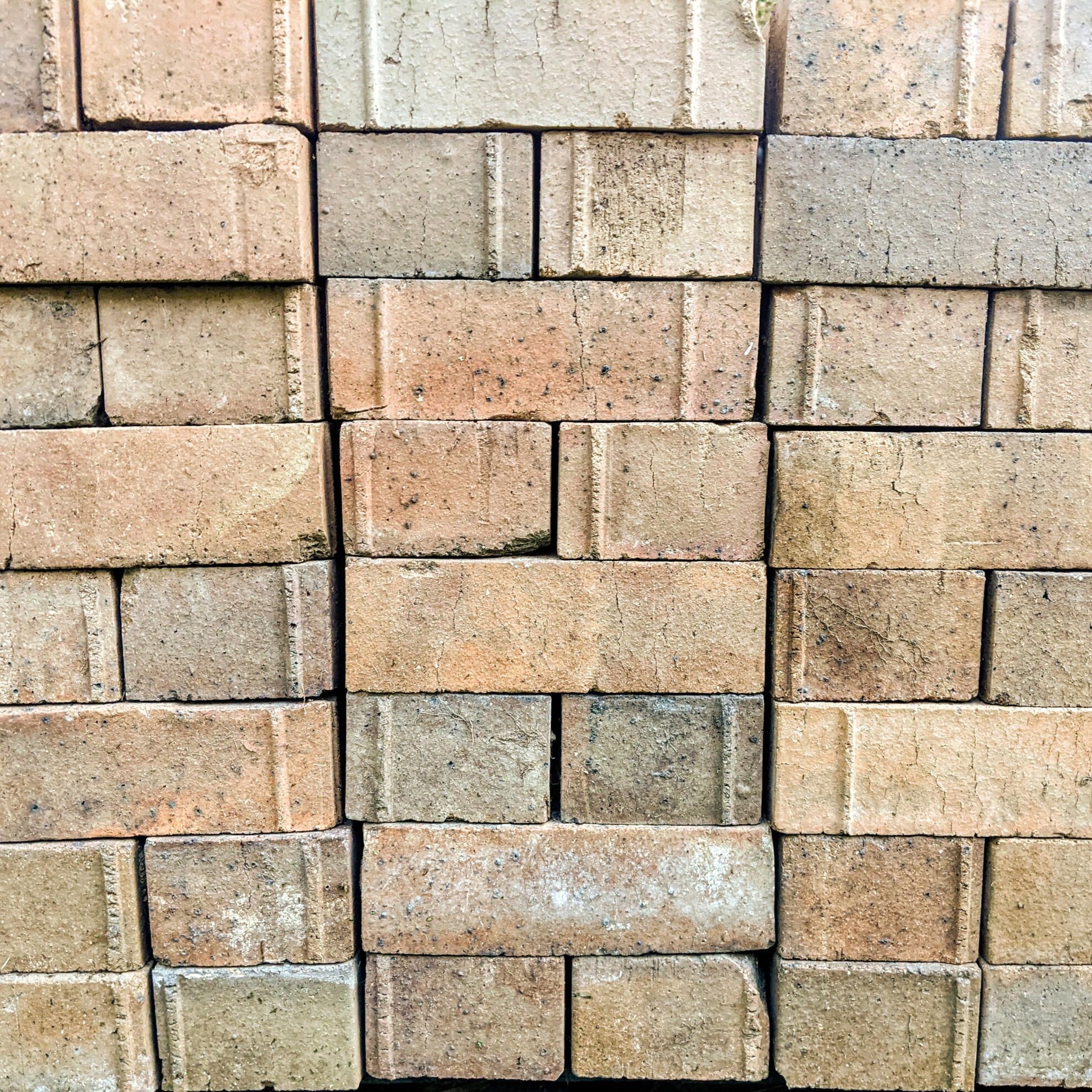 Oxley Farmhouse Salvaged Brick Texture Studio Violett Oxley Farmhouse salvaged face bricks stacked on site showcasing textured earth tones and tactile material reuse